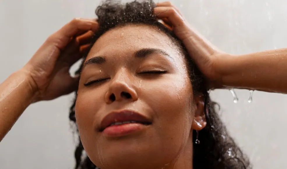 Up close picture o woman rinsing her hair in the shower