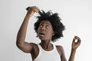 A woman looking up at her stretched out breaking hair